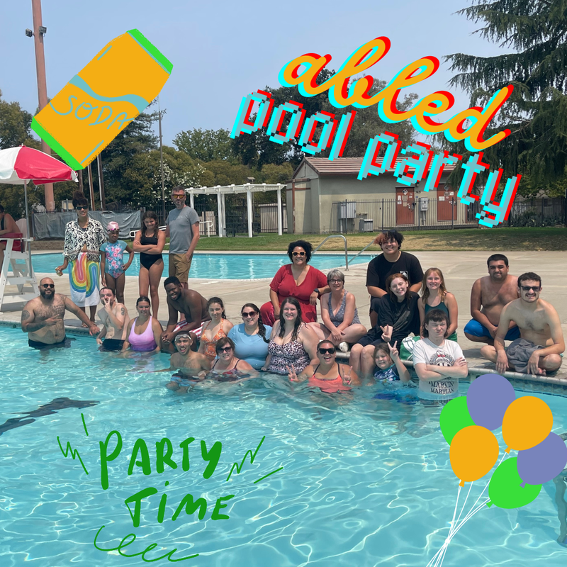 ABLED clients posing in a community pool at a pool party
